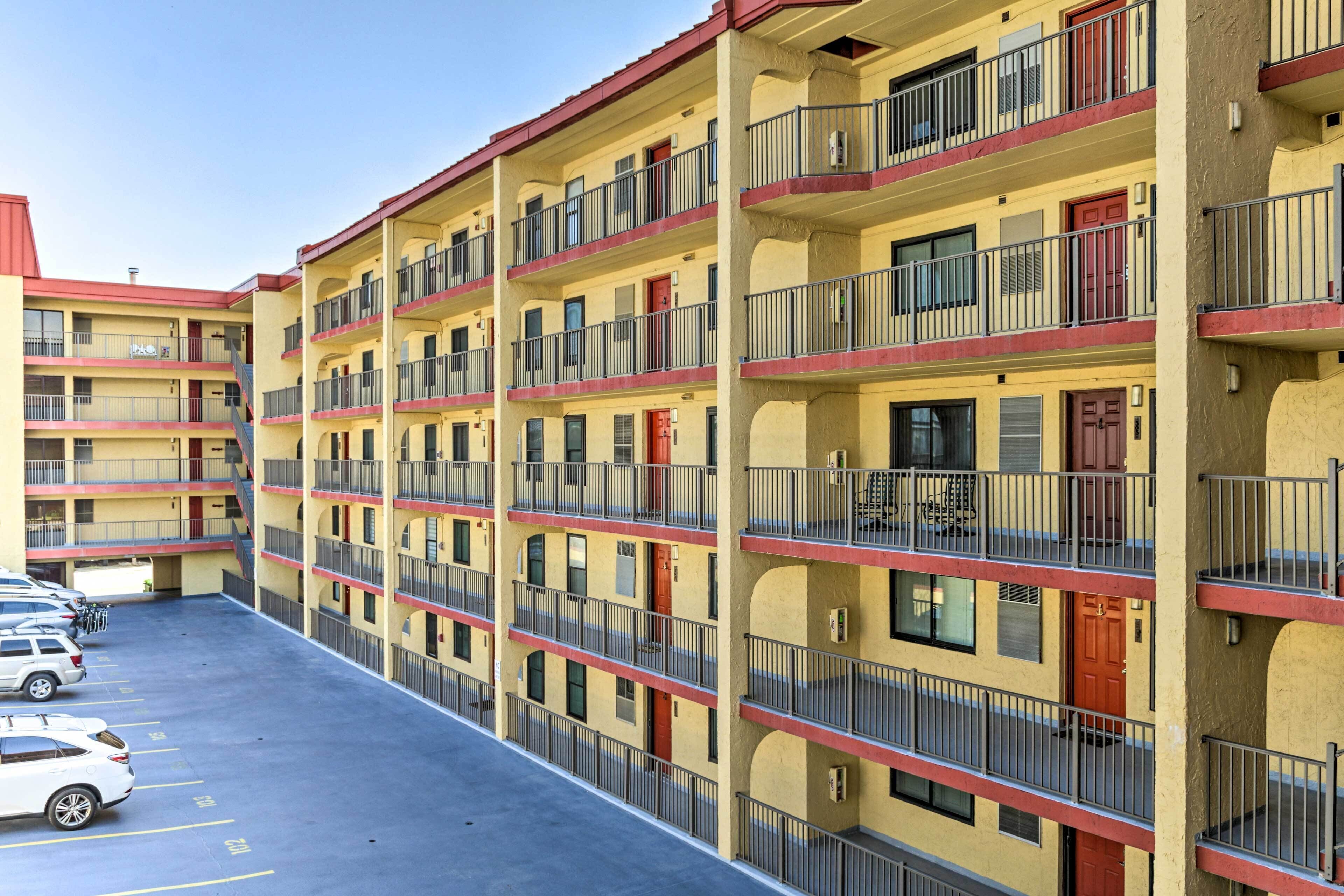 A multi-story motel with a parking lot.