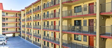 A multi-story motel with a parking lot.
