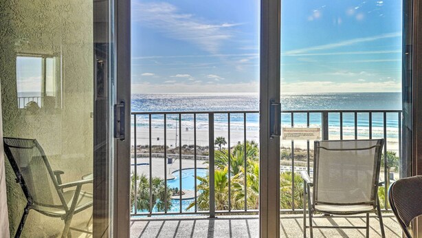 A balcony with a view of the ocean and a pool. - Chic PCB Condo w/ Pool Access + Beachfront Balcony (Panama City Beach)