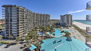A multi-story hotel with balconies, a pool area, and a beach view. - Chic PCB Condo w/ Pool Access + Beachfront Balcony (Panama City Beach)