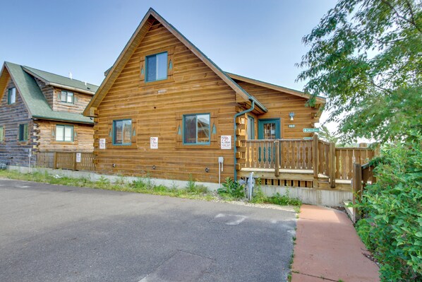 A wooden cabin with a sloped roof, a front porch, and a visible address sign. - Three Bears Resort Adventure Base w/ Lake Access (Warrens)
