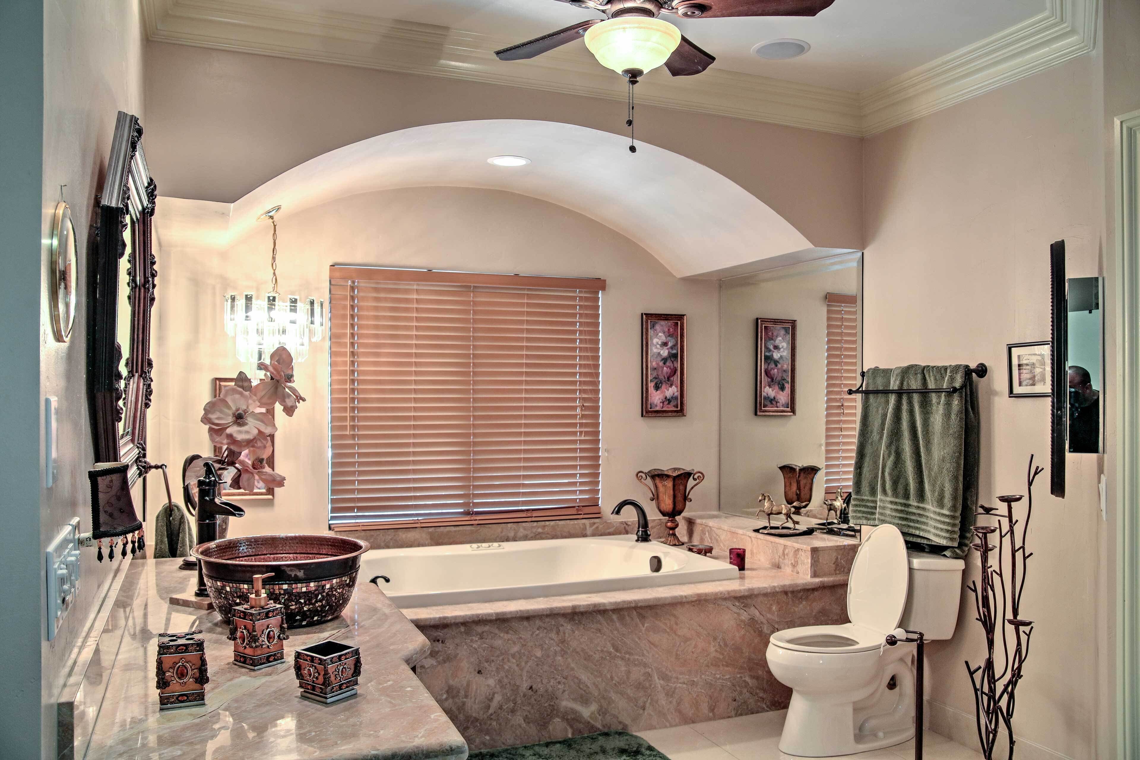A bathroom with a bathtub, toilet, and sink.