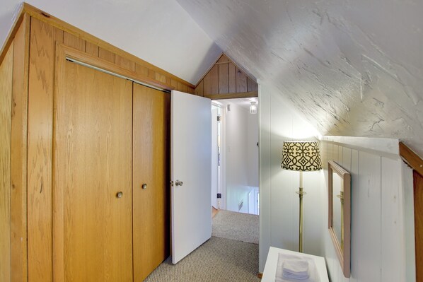 A room with wooden doors, a white ceiling, and a lamp.