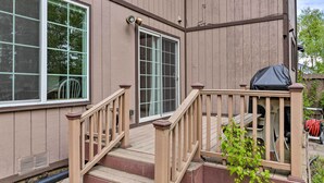 Ein Haus mit Holzterrasse, Schiebetür und überdachter Veranda.
