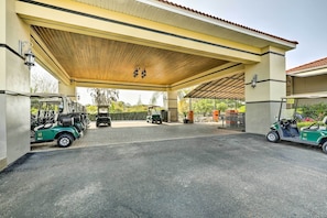 A covered parking area with golf carts and a golf cart with a number 14 on it. - Upscale Unit in Private Golf Resort w/ Pool! (Tampa)