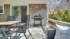 An outdoor patio with a grill, a dining table, and chairs. - Cape Cod Family Home w/ Yard: Walk To Beach! (West Yarmouth)