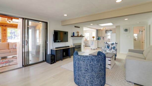 A modern living room with a flat-screen TV, a fireplace, and a dining area. - Charming West Yarmouth Home ~ 2 Mi to Beach! (West Yarmouth)