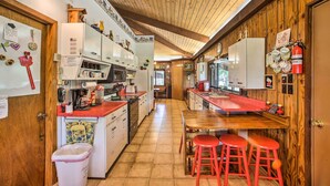A kitchen with wooden cabinets, a red countertop, and a wooden ceiling. - 'pine Lodge Cabin' on 450 Acres in Ozark Mountains (Compton)