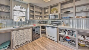 A modern kitchen with built-in appliances, ample storage, and a large window. - Authentic Escape at the Exact Center of CA! (North Fork)