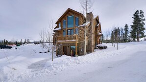 A large log cabin with multiple levels and large windows, surrounded by snow and trees. - Colorado Lodge w/ Mtn Views - 3 Mi to Winter Park! (Winter Park)