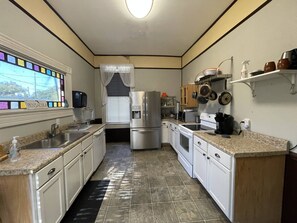 Enjoy cooking in this well-equipped kitchen with a refrigerator, oven, and microwave, plus a convenient sink and ample storage.