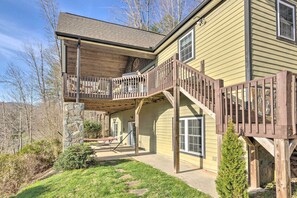 A two-story house with a wooden deck and a stone pillar. - Asheville Retreat w/ Game Room & Mountain Views! (Asheville)