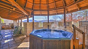 A hot tub under a wooden gazebo with stone walls and a view of mountains. - 11 Mi to Dtwn: Murphy Gem w/ Hot Tub & Mtn Views! (Murphy)