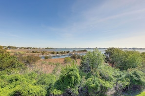 A coastal landscape with a marina, boats, and a clear sky.