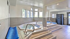 A spa area with two hot tubs, a blue mat, and a set of stairs leading to the tubs. - < 1 Mi to Peak 8: Ski Condo in Breck w/ Mtn Views (Breckenridge)