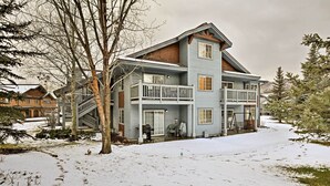 A two-story house with a balcony and a staircase leading to the upper floor. - Steamboat Springs Condo w/ Hot Tub & Ski Bus! (Steamboat Springs)