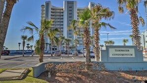 A beachfront condominium with a sign reading "Tidewater Condominium."