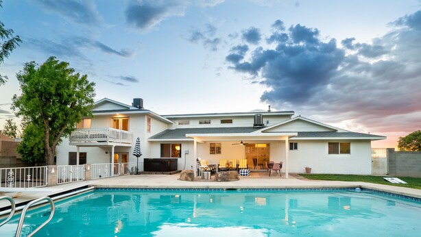 A two-story house with a swimming pool, outdoor seating, and a covered patio area. - Family&Groups, 5br, Sleep 12, Pool/Hot tub/Firepit (Albuquerque)