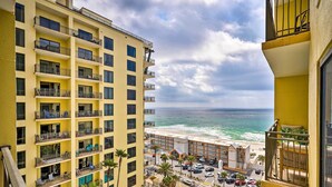 A high-rise hotel with multiple balconies, a pool area, and a view of the beach and ocean. - Chic Panama City Beach Condo w/ Pool & Gulf Views (Panama City Beach)