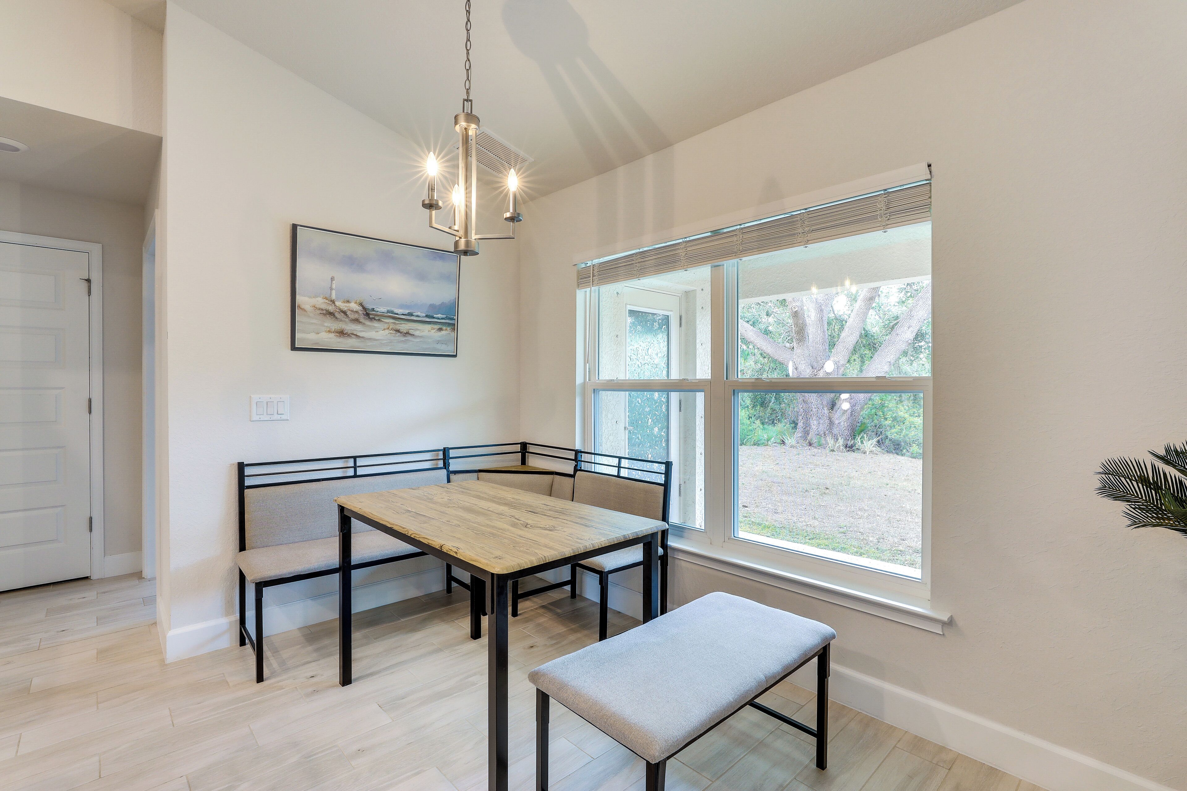 A dining area with a wooden table, benches, and a bench seat.