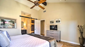 A bedroom with a bed, a television, a dresser, and a ceiling fan. - Kerrville Retreat on 18th Hole of Riverhill! (Kerrville)