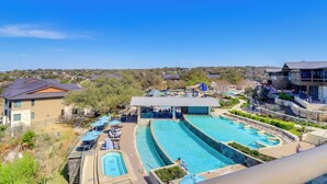 A resort with multiple swimming pools, outdoor seating areas, and a view of the surrounding landscape. - Top-floor Lake-view Condo w/ Boat Dock Access (Lakeway)
