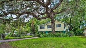 A house with a large tree in front, surrounded by a grassy yard and a brick path. - Waterfront Inglis Getaway w/ Dock: 5 Mi to Gulf (Inglis)