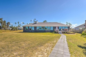 A single-story house with a paved walkway leading to a front porch. - Waterfront Callaway Bayou Home w/ View & Boat Slip (Panama City)
