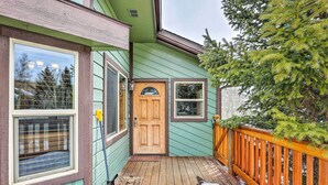 A wooden deck with a snow-covered ground, a wooden door, and a window with a view of trees. - Silverthorne Ski Base w/ Mtn Views: Walk to Trails (Silverthorne)