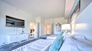 A modern hotel room with two beds, a flat-screen TV, a desk, and a walk-in closet. - Orlando Family Condo ~ 9 Mi to Magic Kingdom! (Orlando)