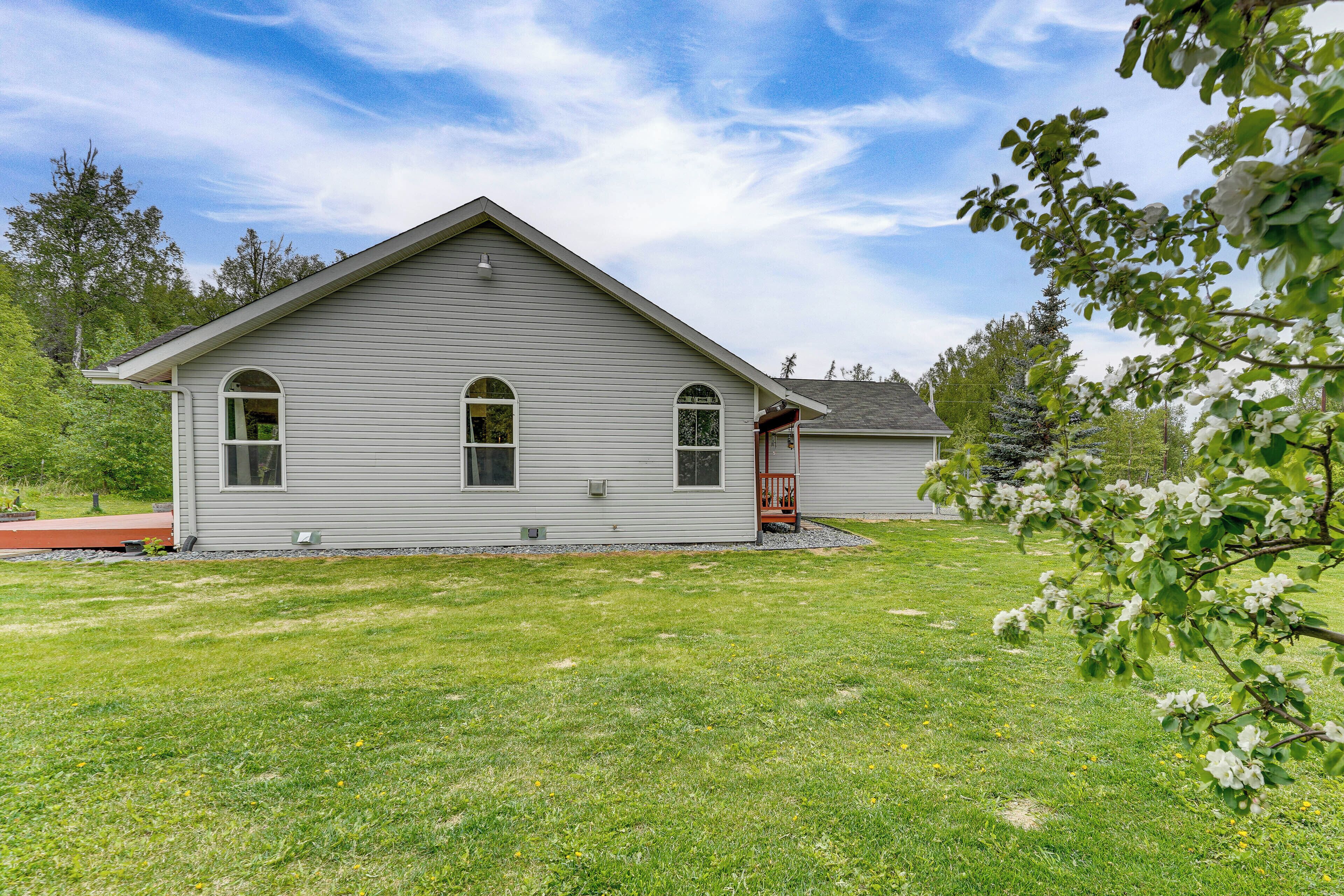 A single-story house with a gabled roof, a front porch, and a well-maintained lawn.