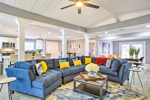 A spacious living room with a sectional sofa, a coffee table, and a ceiling fan. - Vibrant Terrytown Home w/ Yard ~ 6 Mi to Nola (Gretna)