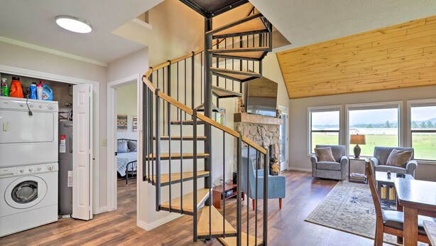 A modern interior with a spiral staircase, a dining area with a view, and a laundry room. - Peaceful Pagosa Springs Escape ~ 2 Mi to Lake (Pagosa Springs)