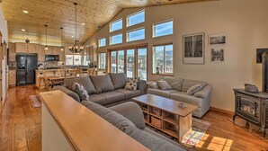 A spacious living area with a large sectional sofa, a wooden coffee table, and a fireplace. - Mountain-view Deck: South Lake Tahoe Retreat! (South Lake Tahoe)