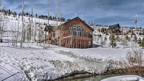 A cabin with a large deck, surrounded by snow-covered landscape and trees. - Mountain-view Deck: South Lake Tahoe Retreat! (South Lake Tahoe)