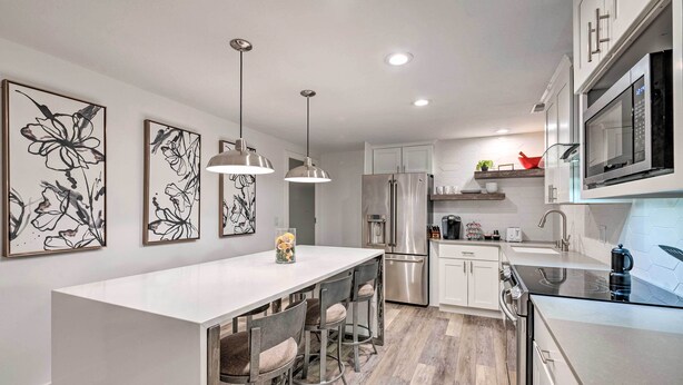 A modern kitchen with a central island, stainless steel appliances, and contemporary decor. - Near Snowbird & Alta Resorts: Winter Getaway (Salt Lake City)