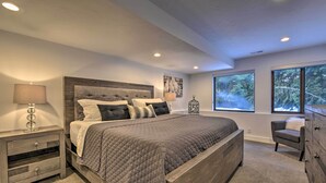 A bedroom with a large bed, a nightstand, a dresser, and a chair. - Near Snowbird & Alta Resorts: Winter Getaway (Salt Lake City)