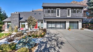 A modern two-story house with a stone facade, a red door, and a garage. - Near Snowbird & Alta Resorts: Winter Getaway (Salt Lake City)