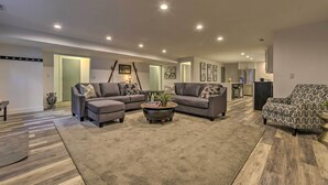 A modern living room with two grey sofas, a patterned armchair, and a coffee table. - Near Snowbird & Alta Resorts: Winter Getaway (Salt Lake City)
