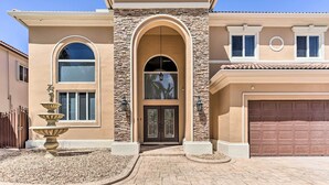 A two-story house with a stone facade, a large arched entrance, and a garage. - Spacious Miami Retreat w/ Grill, Pool & Dock! (Miami)