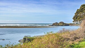 A coastal landscape with a rocky outcrop, a wooden viewing platform, and a clear view of the ocean. - Rustic Coastal Smith River Cottage w/ Ocean Views! (Smith River)