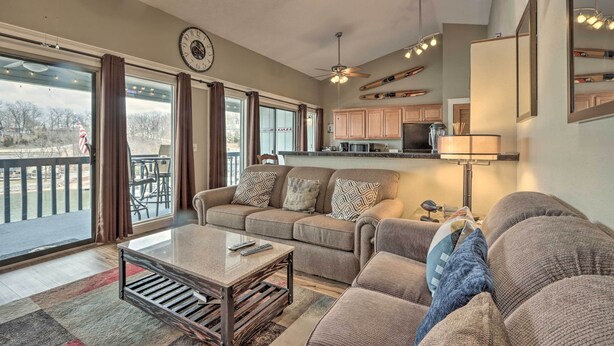 A spacious living room with a sofa, coffee table, and a view of a balcony.