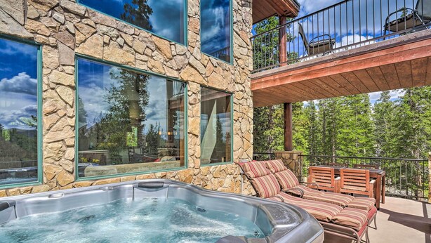 A stone building with a hot tub and outdoor seating. - 26-0111 Fairplay Home w/ Hot Tub & Mountain Views! (Fairplay)