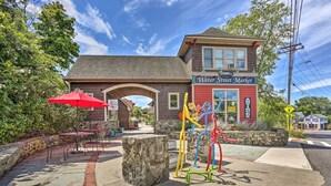 A building with a red storefront labeled "Water Street Market" and a stone archway entrance. - High Falls Restorative Cabin in the Woods! (High Falls)