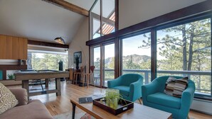 A spacious living area with a wooden coffee table, teal armchairs, and a pool table. - Chic Boulder Mountain Home w/ Hot Tub + Views (Boulder)