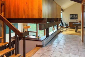 A wooden staircase with a view of a dining area and a pool table. - Chic Boulder Mountain Home w/ Hot Tub + Views (Boulder)