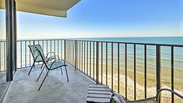 A balcony with a view of the beach, a metal railing, and two chairs. - Oceanfront Oasis w/ Deck and Resort Beach Access! (Murrells Inlet)