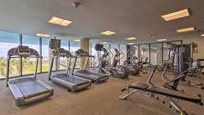 A gym with treadmills, elliptical machines, and weight equipment. - Dauphin Island Condo w/ Pool, Balcony & Ocean View (Dauphin Island)