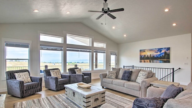 A spacious living room with large windows, a ceiling fan, and a painting on the wall. - Garden City Retreat w/ Access to Bear Lake! (Garden City)