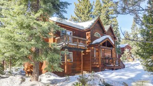 A large wooden cabin with multiple balconies, surrounded by snow and pine trees. - 7 Mi to Northstar Resort: Tahoe Vista Family Cabin (Kings Beach)